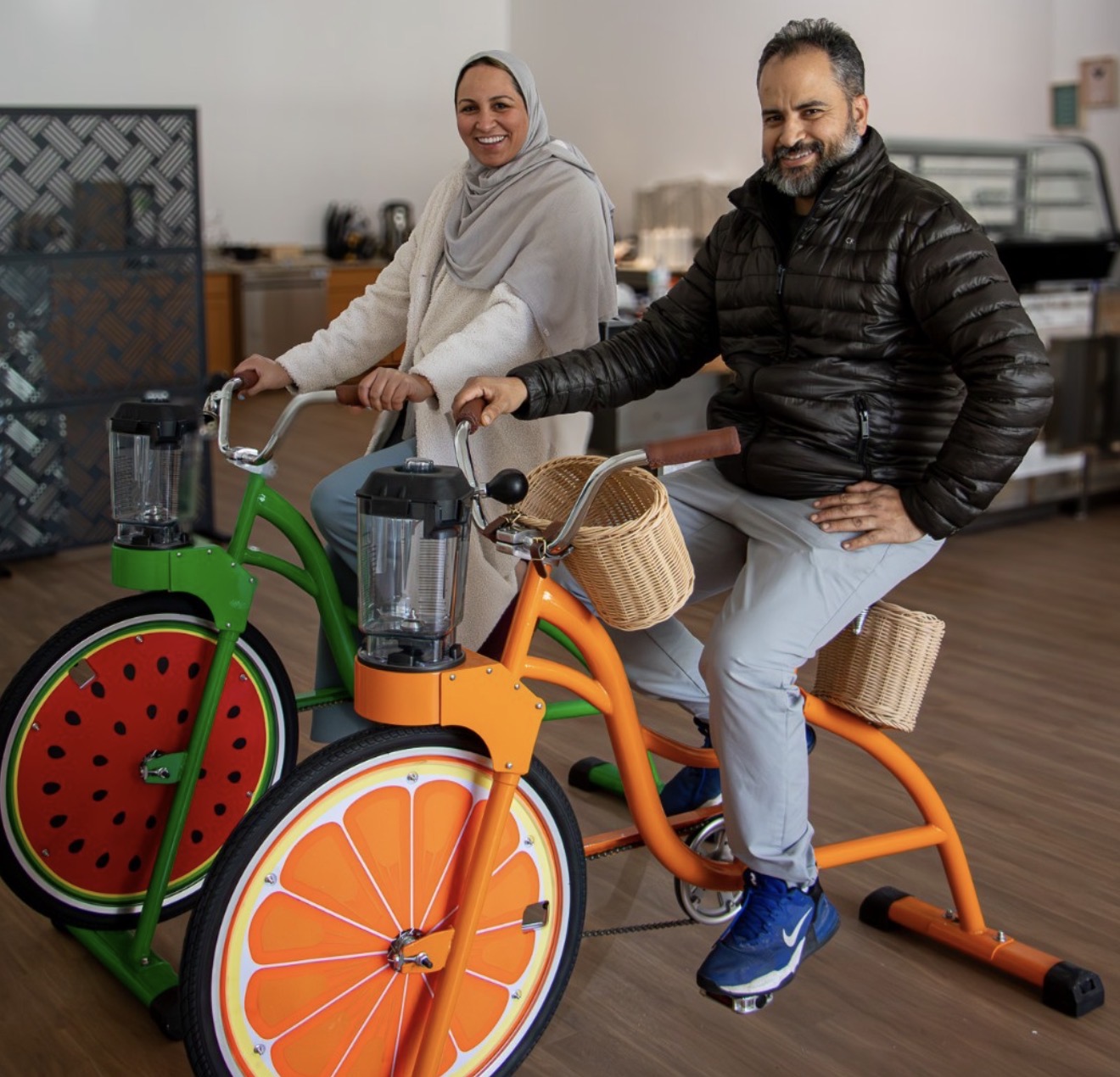 Layan and her husband on the new pedal-powered smoothie bikes inside the shop